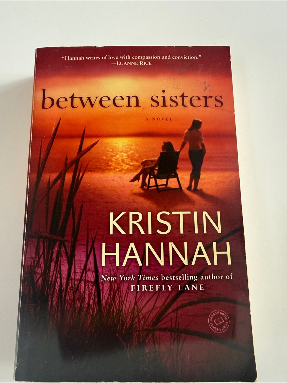 Between Sisters by Kristin Hannah - Sunset Orange Paperback